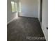 Cozy bedroom with a bright window, neutral paint, and soft carpeting for a comfortable living space at 4362 Denmark Ct, Denver, CO 80239
