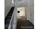 Inviting entryway featuring a carpeted staircase and an open view of the living area with a fireplace at 4362 Denmark Ct, Denver, CO 80239