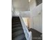 Bright entryway with carpeted stairs, white walls, and a welcoming front door, leading to the upper level at 4362 Denmark Ct, Denver, CO 80239