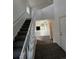 Bright foyer featuring stairs, carpeted floors, and natural light, offering a warm welcome into the home at 4362 Denmark Ct, Denver, CO 80239