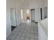 Well-lit hallway with tiled flooring, connecting various rooms and featuring closet space for convenient storage at 4362 Denmark Ct, Denver, CO 80239