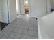 Tiled hallway with a clear view into a bathroom, showcasing well-maintained features and neutral tones at 4362 Denmark Ct, Denver, CO 80239