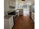 Well-lit kitchen featuring white cabinets, stainless steel appliances, and a seamless transition to the adjacent dining area at 4362 Denmark Ct, Denver, CO 80239