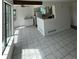Bright living room with large windows and tile floors connects to the kitchen at 4362 Denmark Ct, Denver, CO 80239