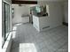 Open-concept living space with tile flooring that flows into the kitchen, blending cooking and socializing at 4362 Denmark Ct, Denver, CO 80239