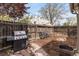 Fenced backyard featuring stone patio and a mulched planting area with a fire pit at 3953 Tejon St, Denver, CO 80211