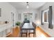 Light-filled dining room features sleek table and hardwood floors, seamlessly connected to living area at 3953 Tejon St, Denver, CO 80211