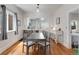 Elegant dining room with hardwood floors, ample seating, and a view into the modern kitchen at 3953 Tejon St, Denver, CO 80211