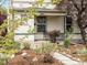Cozy front porch with small seating area, complemented by a well-maintained garden and charming landscaping at 3953 Tejon St, Denver, CO 80211