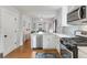 Charming kitchen connects to dining room with stainless appliances and breakfast bar at 3953 Tejon St, Denver, CO 80211
