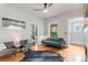 Spacious living room with hardwood floors, a fireplace, and plenty of natural light at 3953 Tejon St, Denver, CO 80211