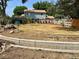 Backyard showcasing a retaining wall, mature trees, and a wooden fence that frames the property at 8501 W 52Nd Ave, Arvada, CO 80002
