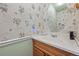 Bathroom featuring a vanity with a sink and floral wallpaper at 8501 W 52Nd Ave, Arvada, CO 80002