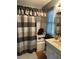 Bathroom featuring a neutral colored shower curtain, vanity, and wood-look floors at 8501 W 52Nd Ave, Arvada, CO 80002