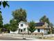 Home with solar panels, white picket fence and mature trees for shade in the front yard at 8501 W 52Nd Ave, Arvada, CO 80002