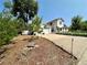 Home exterior featuring a driveway, garage, and white picket fence with nice landscaping at 8501 W 52Nd Ave, Arvada, CO 80002