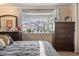 Comfortable main bedroom with large bay window, dresser, and neutral decor at 8501 W 52Nd Ave, Arvada, CO 80002