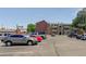 A parking lot is in front of apartment building with trees and clear sky at 10150 E Virginia Ave # 18-302, Denver, CO 80247