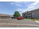 Apartment building with ample parking and well-maintained landscaping on a beautiful, sunny day at 10150 E Virginia Ave # 18-302, Denver, CO 80247