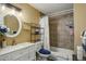 Bathroom with white single sink vanity, shower over bath, and accent lighting at 10150 E Virginia Ave # 18-302, Denver, CO 80247