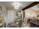 Charming dining room featuring stylish chairs, chandelier, and a view into the living area at 10150 E Virginia Ave # 18-302, Denver, CO 80247