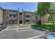 Exterior of two-story building with assigned parking and landscaping at 10150 E Virginia Ave # 18-302, Denver, CO 80247