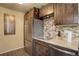Kitchen with stainless steel refrigerator and a modern faucet, surrounded by wooden cabinets at 10150 E Virginia Ave # 18-302, Denver, CO 80247