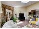 Bright living room with stone fireplace, skylight, and hardwood floors for a warm, inviting ambiance at 10150 E Virginia Ave # 18-302, Denver, CO 80247