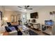 Comfortable living room featuring hardwood floors, large TV and open floorplan at 10150 E Virginia Ave # 18-302, Denver, CO 80247