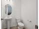 Well-lit powder room with modern fixtures and a pedestal sink at 1244 Penner Dr, Erie, CO 80026