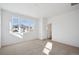 Sunlit bedroom with large windows, new carpet, and a view of the neighborhood at 1244 Penner Dr, Erie, CO 80026