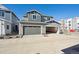 Two story home with a three-car garage and gray siding under a clear blue sky at 1244 Penner Dr, Erie, CO 80026