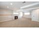 Spacious carpeted basement with a cozy fireplace, recessed lighting, and a clean, modern aesthetic at 2963 S Ivan Way, Denver, CO 80227