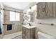 Updated bathroom boasting a glass-enclosed shower, wooden vanity, and stylish modern finishes at 2963 S Ivan Way, Denver, CO 80227