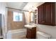 Well-lit bathroom with a shower-tub combo, vanity with storage, and updated fixtures for a modern feel at 2963 S Ivan Way, Denver, CO 80227