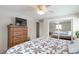 Cozy bedroom featuring a ceiling fan, a closet with mirrored doors, and a TV on a wooden dresser at 2963 S Ivan Way, Denver, CO 80227