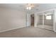 Neutral-toned bedroom with carpet, ceiling fan, mirrored closet, and convenient access to an adjacent room at 2963 S Ivan Way, Denver, CO 80227