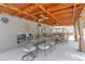 This inviting covered patio features elegant iron chairs and tables with ceiling fans and neutral decor sun details at 2963 S Ivan Way, Denver, CO 80227