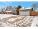 Well-maintained home exterior with a large driveway and attached two-car garage at 2963 S Ivan Way, Denver, CO 80227