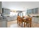 Bright kitchen featuring updated cabinets, stainless steel appliances, and an adjacent dining area at 2963 S Ivan Way, Denver, CO 80227