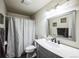 Well-lit bathroom featuring a gray vanity with a marble countertop and framed mirror at 327 N 12Th Ave, Brighton, CO 80601