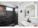 Modern bathroom features black marble shower and vanity with white marble countertop at 327 N 12Th Ave, Brighton, CO 80601