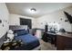 Cozy bedroom with a soft blue comforter and a vanity with a lighted makeup mirror at 327 N 12Th Ave, Brighton, CO 80601