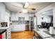 A kitchen features gray cabinets, stainless steel appliances, hardwood floors, and a dining table with chairs at 327 N 12Th Ave, Brighton, CO 80601