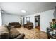 Spacious living room with wood floors, wainscoting, and comfortable brown leather sofas at 327 N 12Th Ave, Brighton, CO 80601