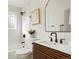 Modern bathroom with stylish vanity, large mirror, and walk-in shower with white subway tile at 211 Newport St, Denver, CO 80220