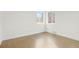 Bright bedroom with hardwood floors and double windows, providing natural light at 211 Newport St, Denver, CO 80220