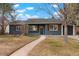 Charming home with a well-maintained front yard, walkway, and inviting entrance at 211 Newport St, Denver, CO 80220