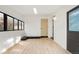 Bright sunroom with white walls and ceiling, light hardwood floors, and a classic brick feature at 211 Newport St, Denver, CO 80220