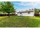 A sprawling backyard with green grass, mature trees, and a privacy fence at 4520 E 112Th Pl, Thornton, CO 80233